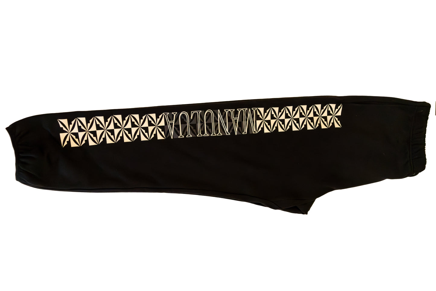 Black bandeau top with gold geometric pattern on a white background